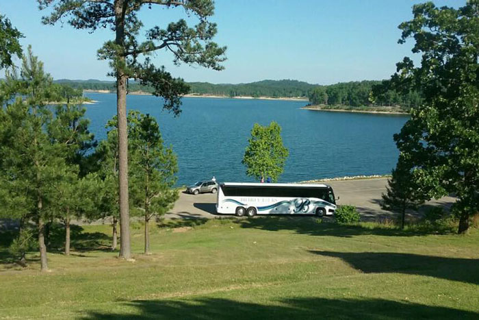 bus by a lake and forest