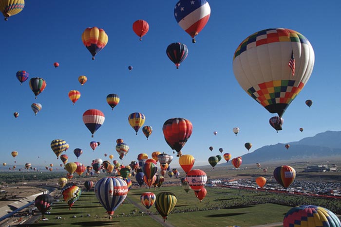 hundreds of hot air balloons rising